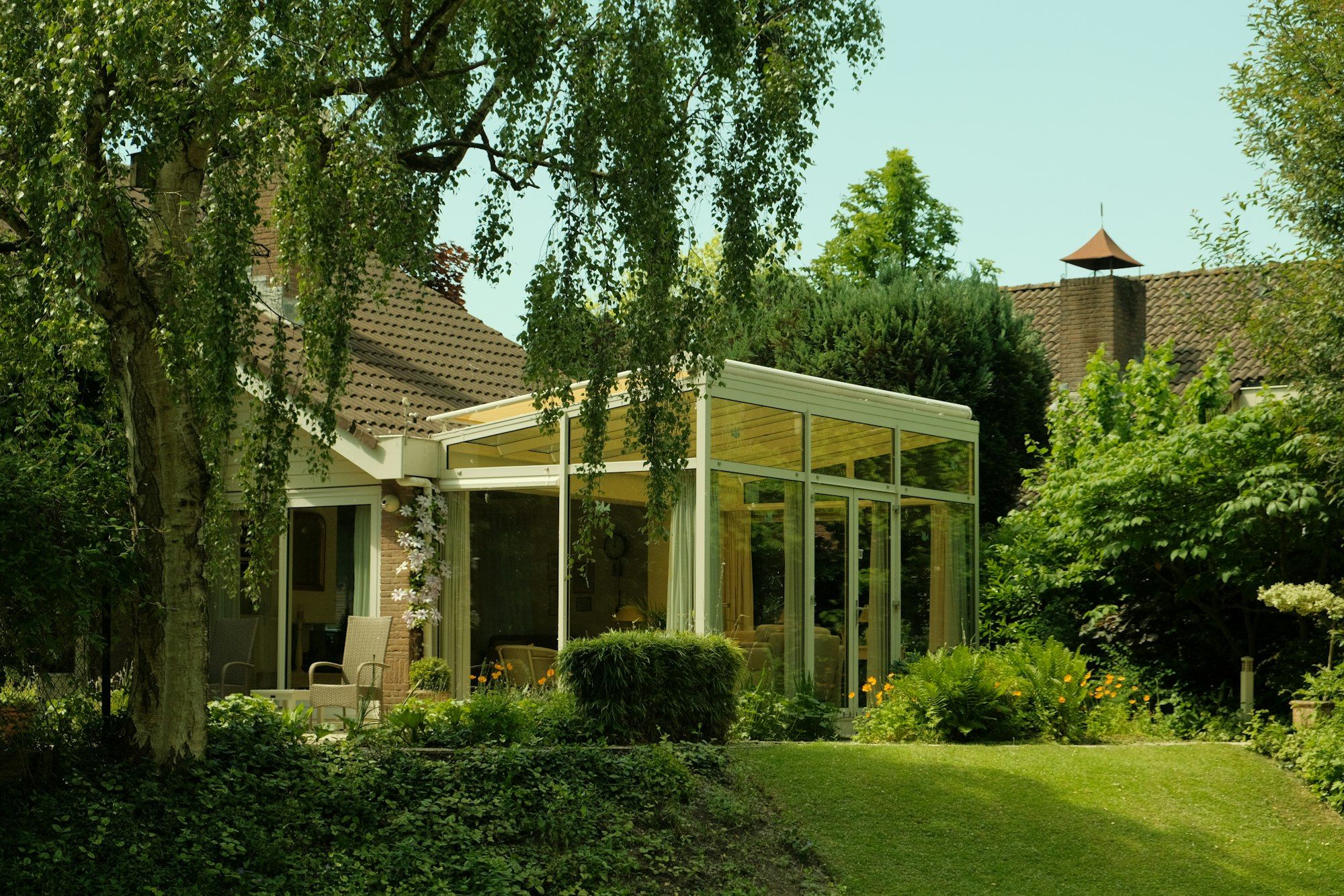 Glass sunroom addition seen from the garden