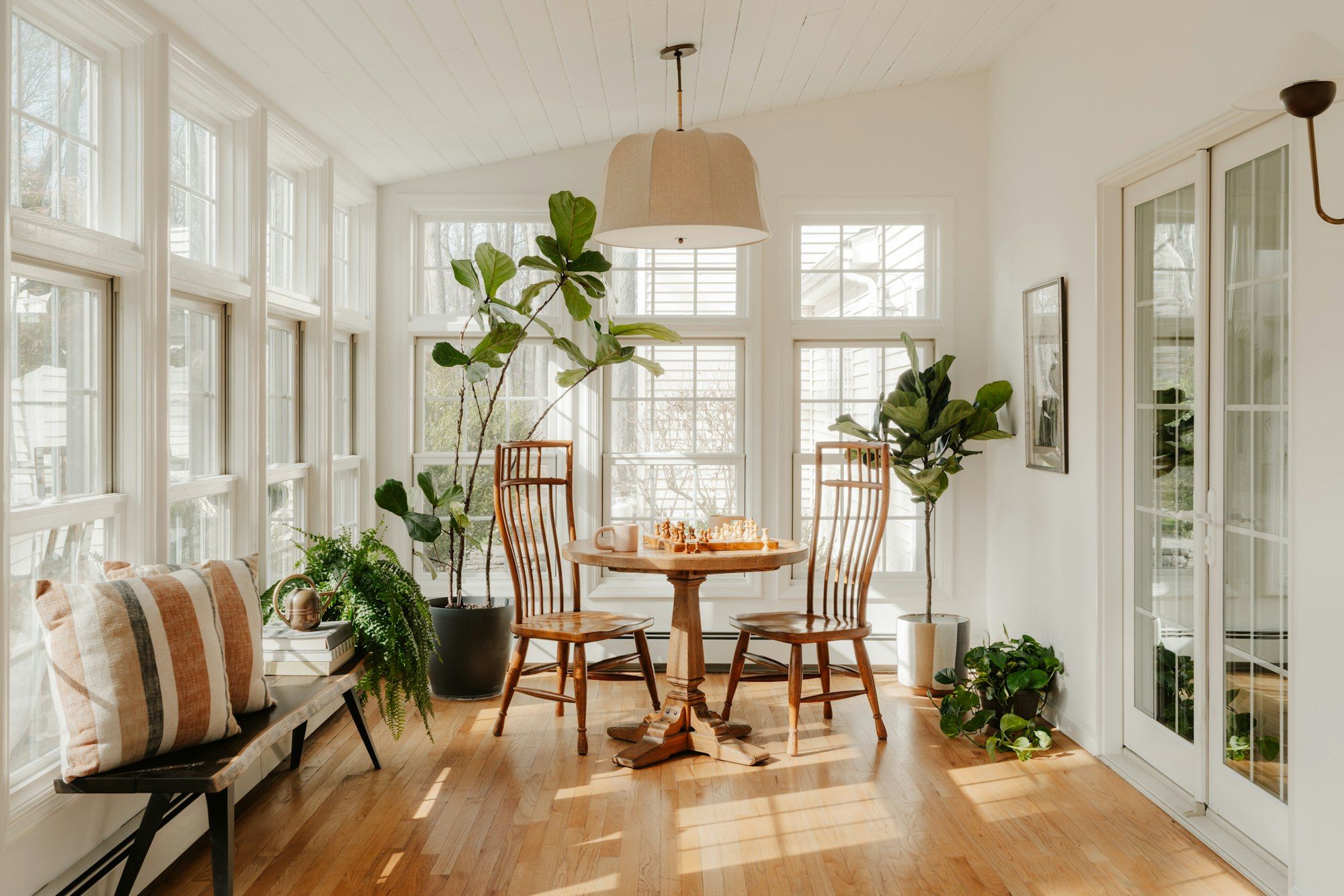 Sunroom interior with a round table and plants
