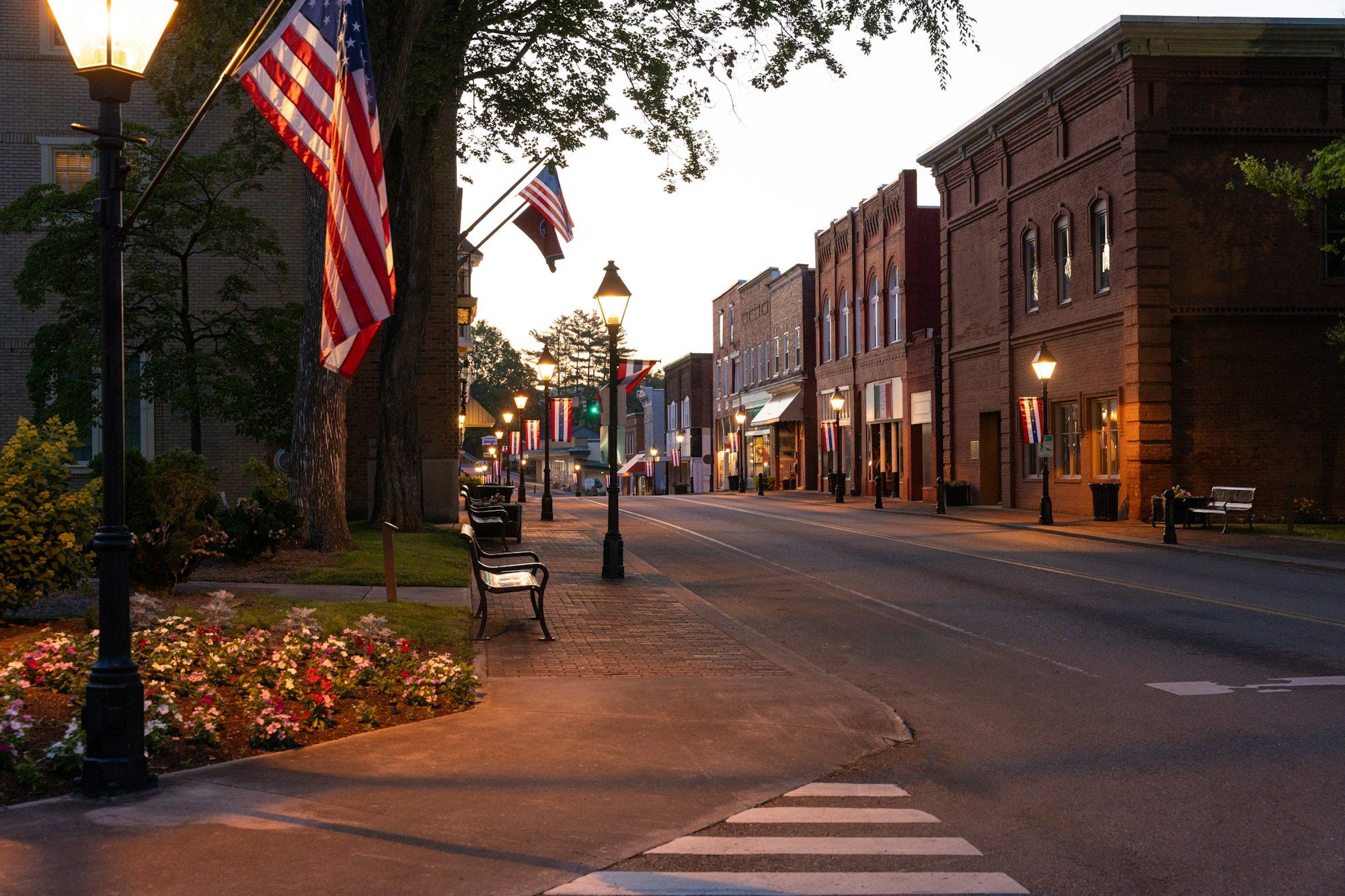 Ashford's main street at dusk with flags on the lamp posts