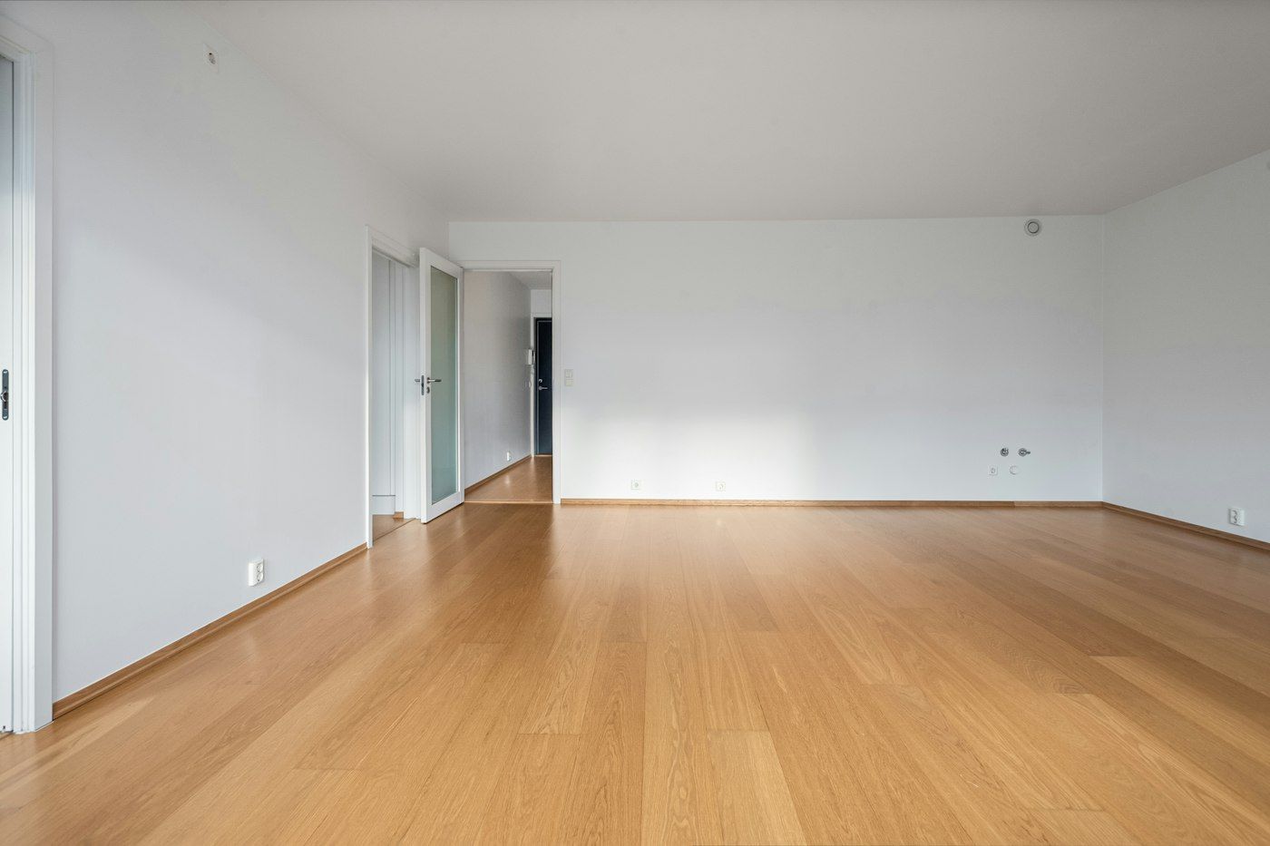 Finished empty room with a new honey oak floor