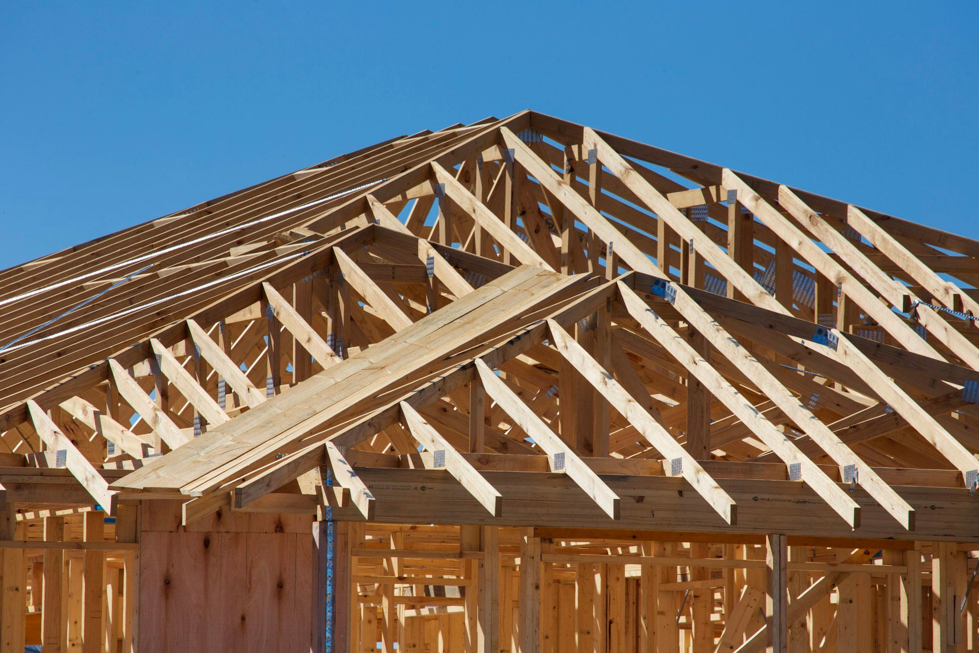 Roof trusses on a new addition against the sky