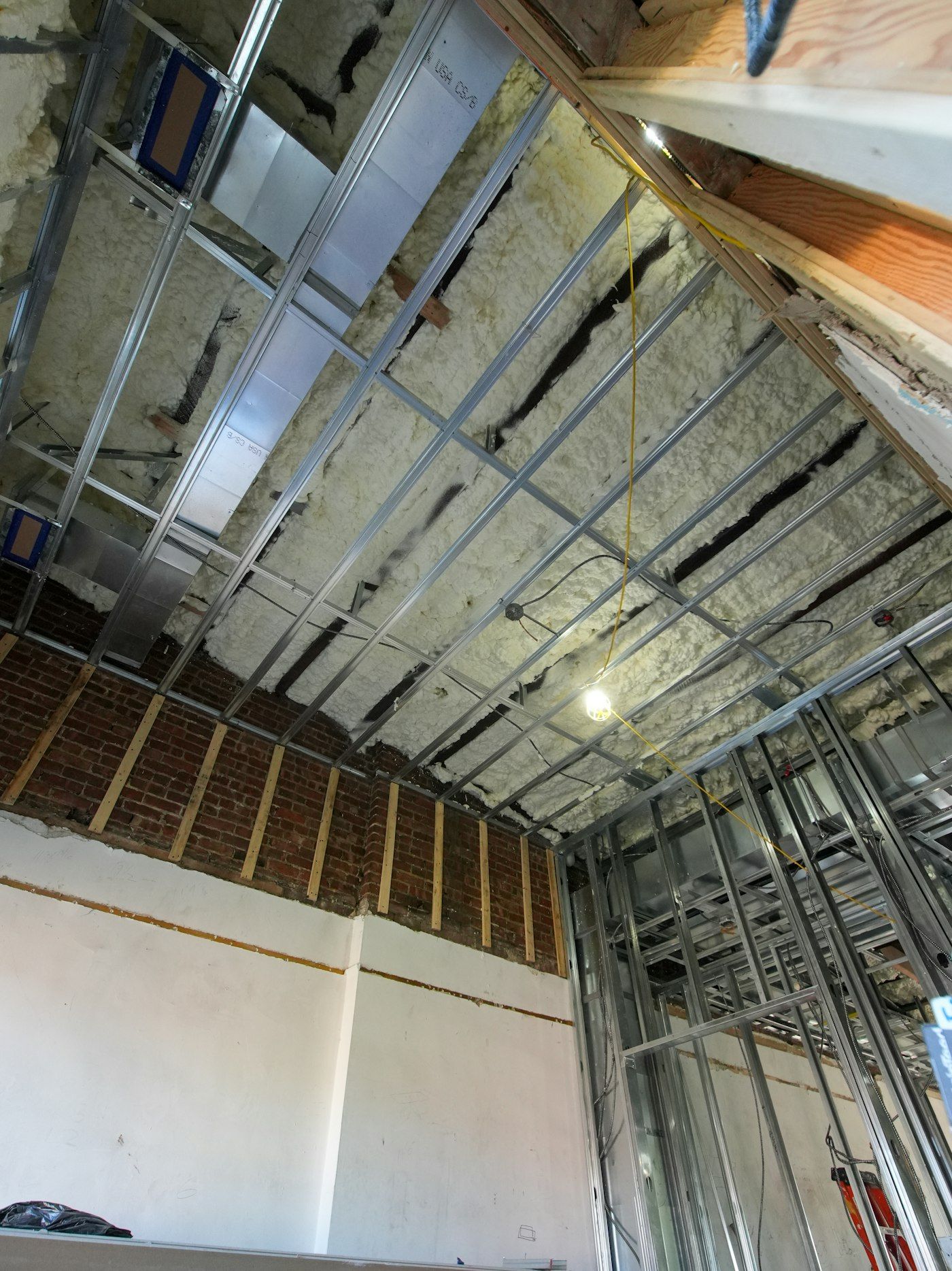 Framed walls and an insulated ceiling in a basement under construction