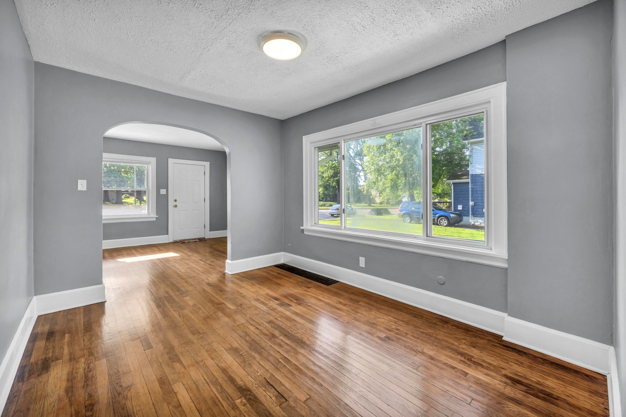 Gray-walled room with glossy dark stained oak floor
